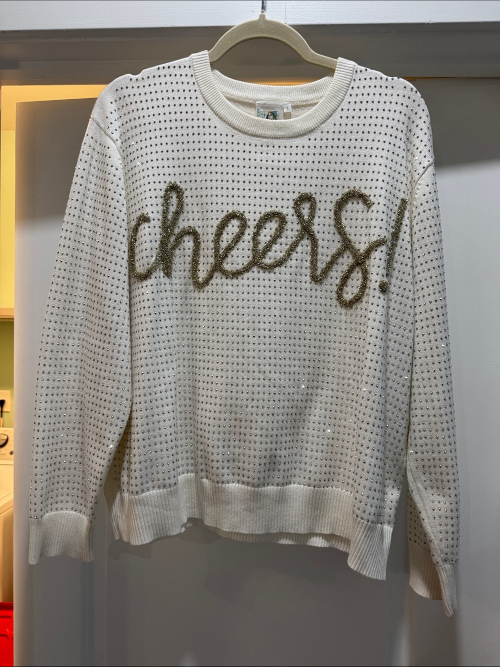 QUEEN OF SPARKLES White Crewneck Sweater with Gold 'cheers' Script
